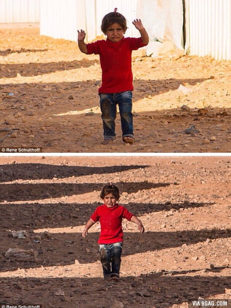 Syrian child mistakes a photographer's camera for a weapon and raises her hands to 'surrender'