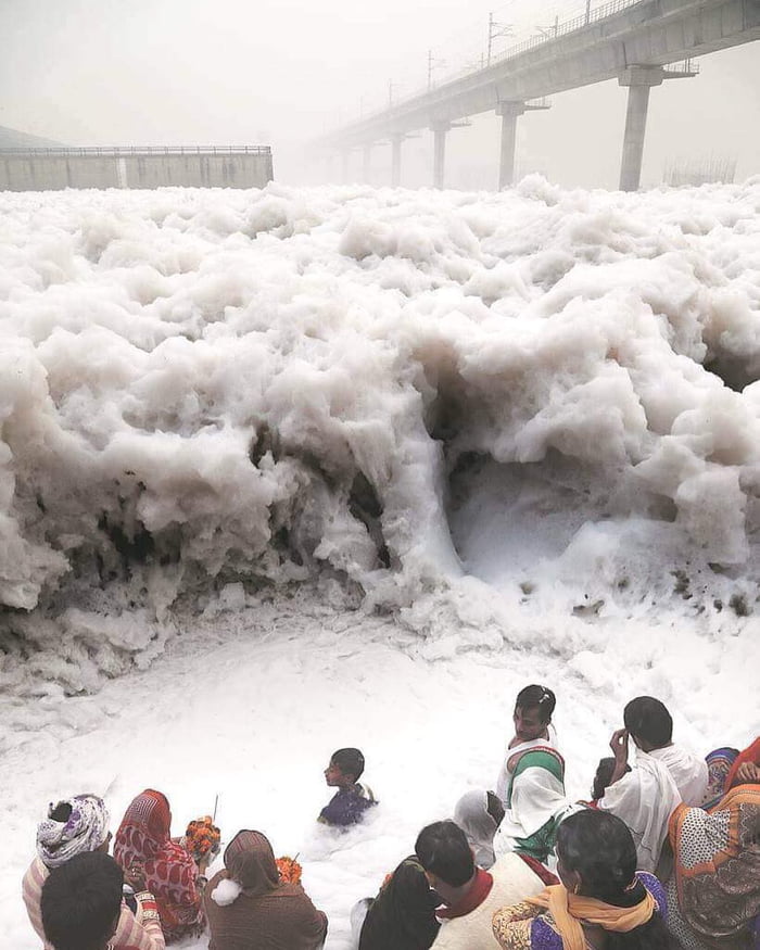 Pilgrims Offer Prayers At The Yamuna River In India Which Is Covered