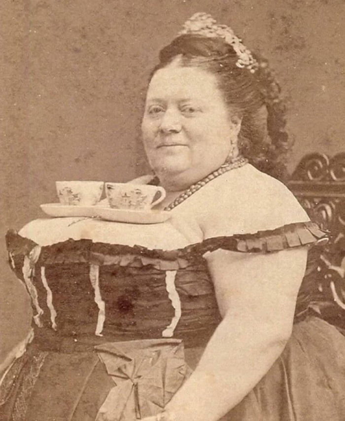 A Woman Balancing Two Cups Of Tea On Her Breasts S Gag