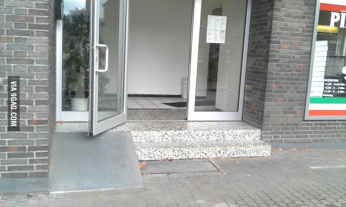 Stairs with a ramp blocked by an open door