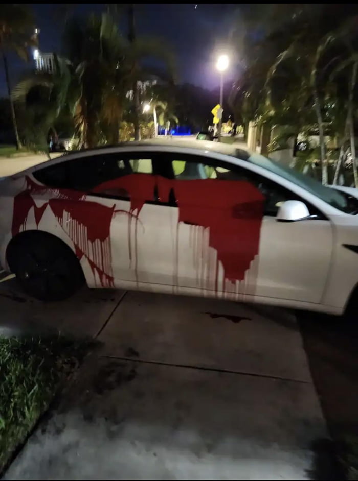 Neighbor parked his Tesla by blocking the sidewalk, someone threw red paint at his car