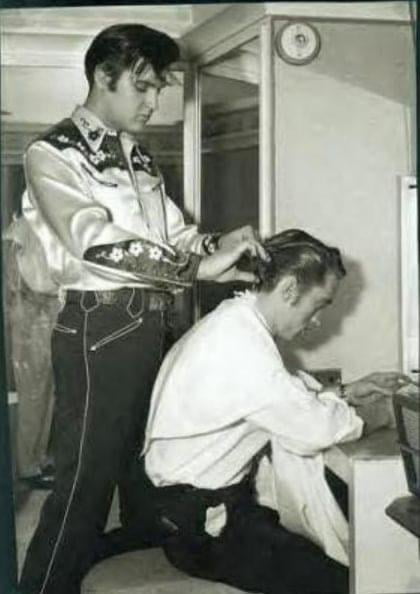Elvis cutting Johnny Cash’s hair. 1956.