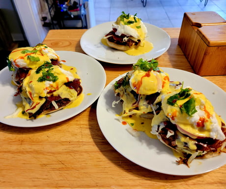 Leftover Birria in a Benedict. Griddled Oaxaca cheese over avocado, venison  and beef Birria, onions and topped with a tomato, cilantro hollandaise and  a dash of Cholula - 9GAG