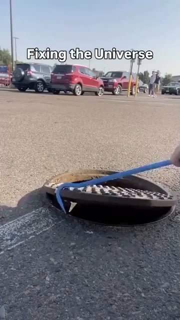 This guy is fixing the universe one manhole cover at a time