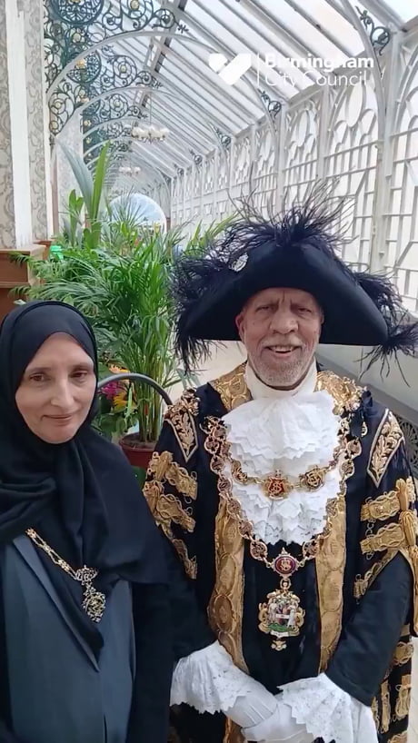 The man speaking broken English is the Mayor of Birmingham with his wife. This is not a joke or satire.