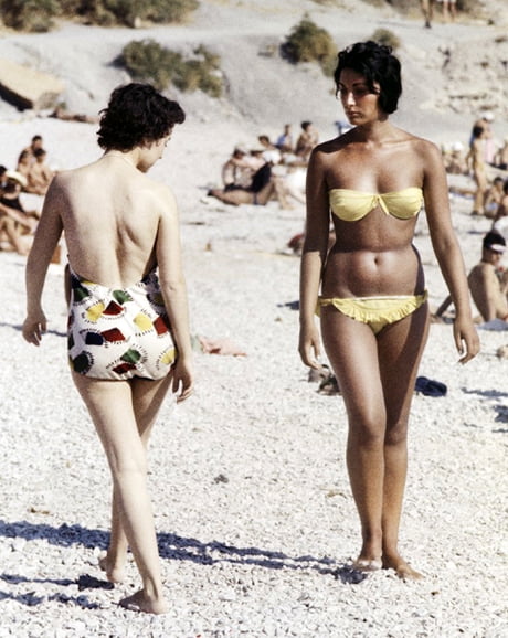 2 women on the beach in the South of France, 1958. The bikini was created  by French designer Louis Réard in 1946, and made popular by Brigitte Bardot  in the 1950s - 9GAG