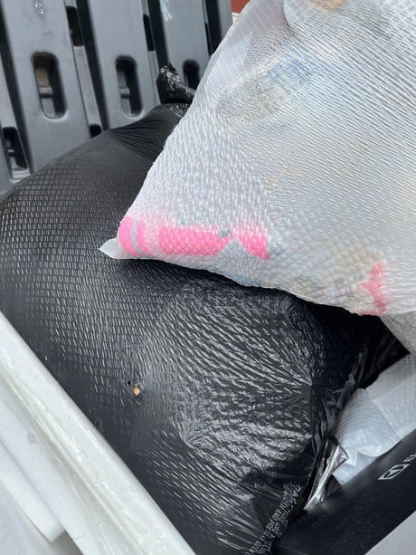 Garbage bag at the top of the dumpster is full of sex toys. And also trash. 