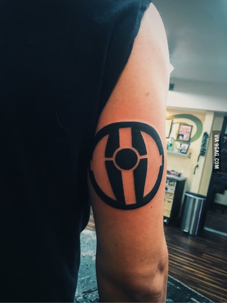 Darth revan tattoo with a purple lightsaber behind his back and red on the  front  rkotor