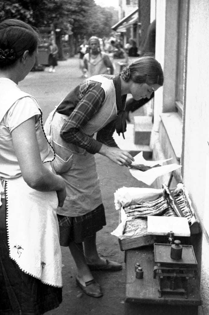 Fish seller selling fish on the street. Hel, Poland, July 1932. - 9GAG