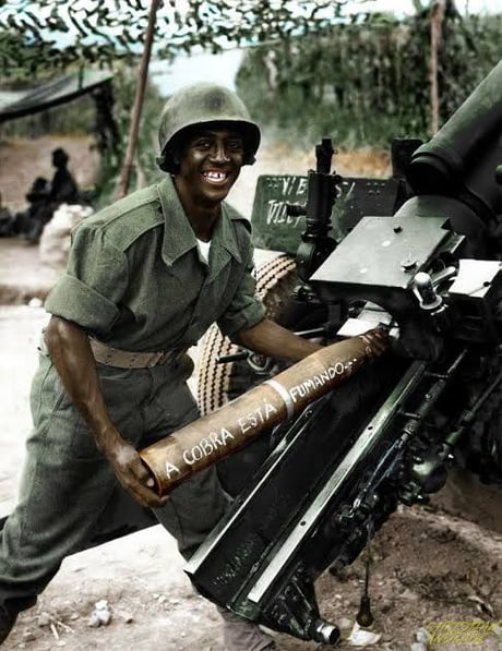 An artilleryman of the Brazilian Expeditionary Forces in Italy loading a  shell that says the snake is smoking. Brazil was the only independent  South American country to send ground troops to fight