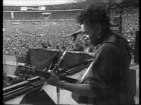 Tracy Chapman - Fast Car (Wembley 1988) After Stevie Wonder was unable to perform, she was asked to play a couple of songs to fill in while they set up the main stage.