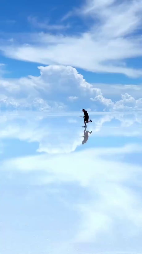 Skimboarding in the clouds in Salar De Uyuni, Bolivia
