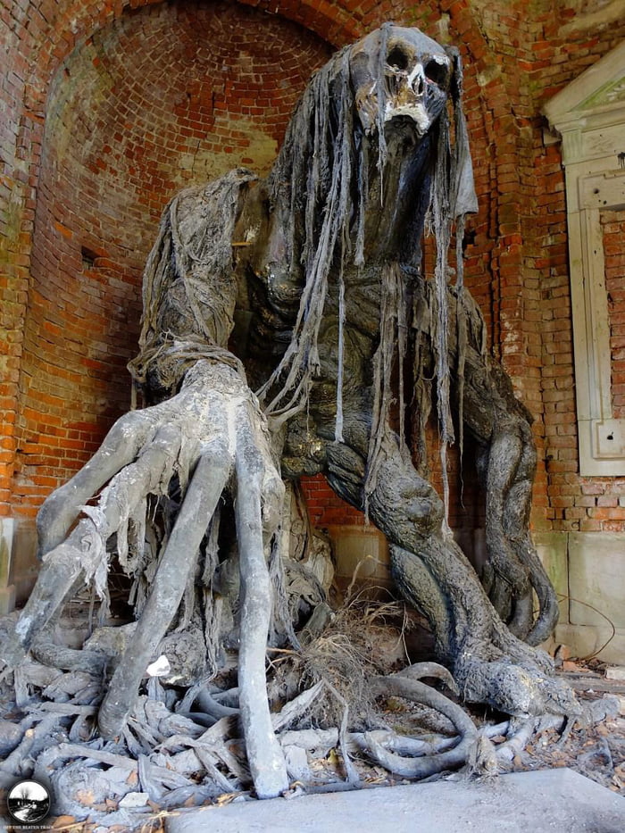 Demon statue at an abandoned mausoleum in Poland