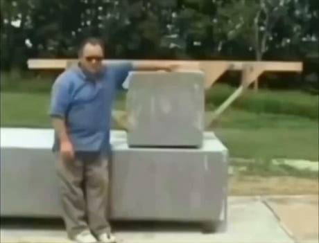 Wally Wellington demonstrates how bricks could have been moved in anceint times