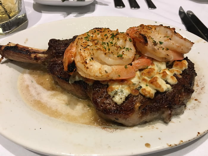 A Ruth Chris' 22 oz cowboy ribeye with a blue cheese crust and six