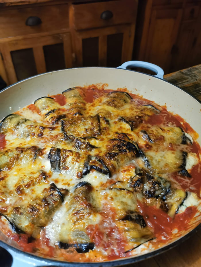 Pan fried aubergines slices stuffed with ricotta cheese & basil baked