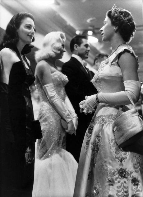 marilyn monroe wore low cut dress to meet the queen Theyre both 30 at this time!, Marilyn Monroe met Queen Elizabeth II at the Royal Command Film Performance in London on October 26, 1956. Monroe wore a gold lam dress that was so low-cut that it
