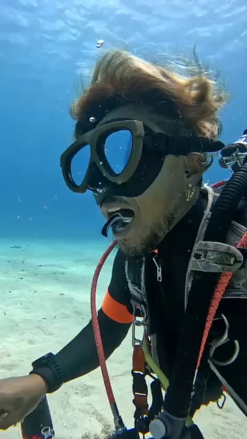 Divers mouth getting cleaned by a fish