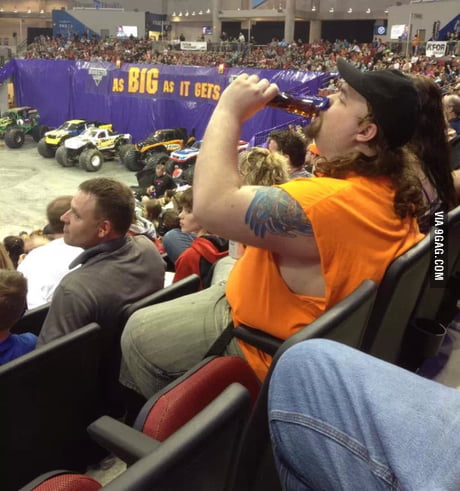Overweight white male with a mullet and a trucker hat, drinking a bottle of  syrup at a monster truck rally. - 9GAG