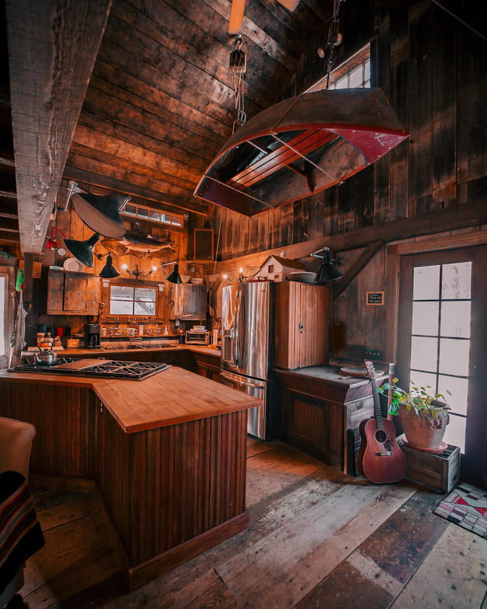 Rustic Cabin Kitchen with a Boat Hanging from the Ceiling 9GAG