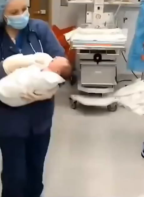 Mother kisses newborn