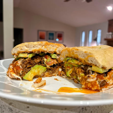 Beef birria wrapped in fried Oaxaca cheese on a fresh telera roll with  avocado and special sauce - 9GAG