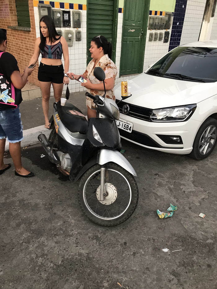 This lady in 2078 using the rearviewmirror as table.