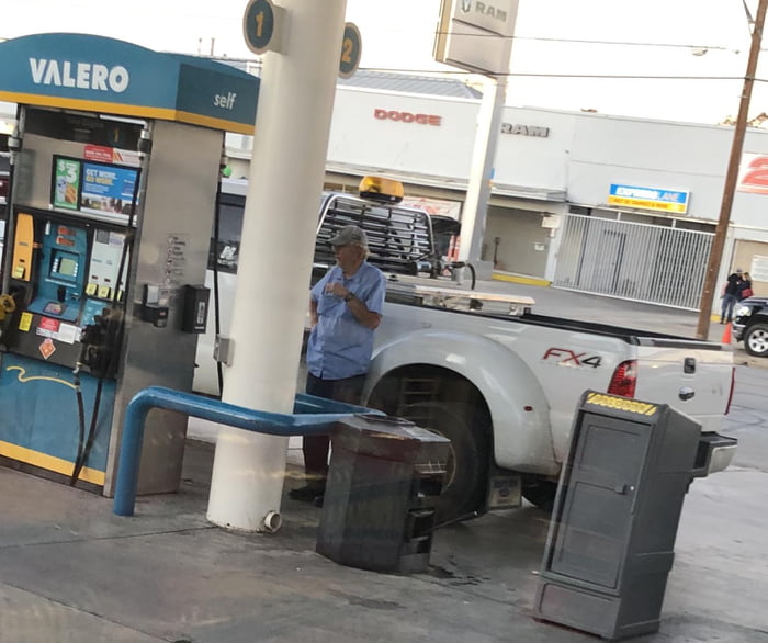 Old man smoking while pumping gas. When the attendant told him he