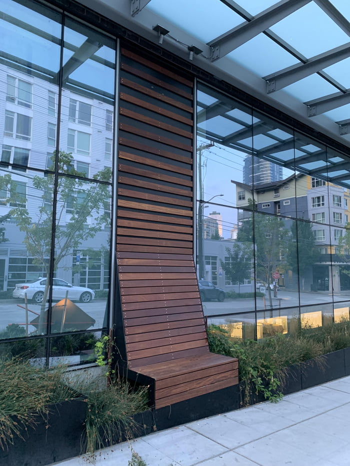 The siding of a building turns into a bench!
