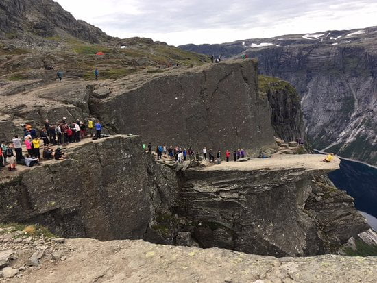 Expectation vs reality: People waiting in line (Trolltunga in Norway) to get their Instagram Picture.