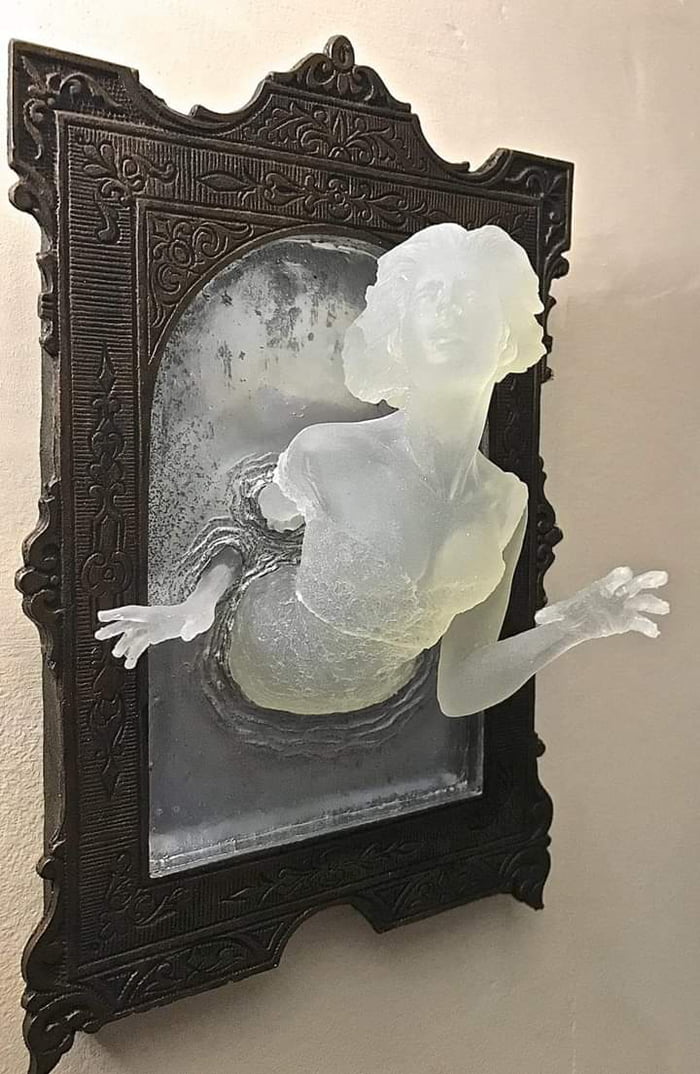 Sculpture of a Victorian ghost emerging from an antique mirror cast in resin