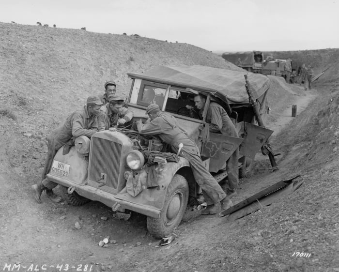 American soldiers check out a German car captured in the Kasserine Pass ...