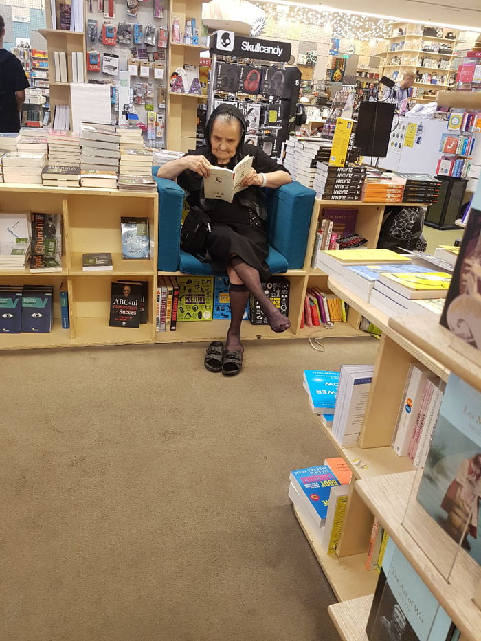 I dare any staff to risk telling her she can't just sit there and read the whole thing. She's rooted, shoes off, legs crossed!