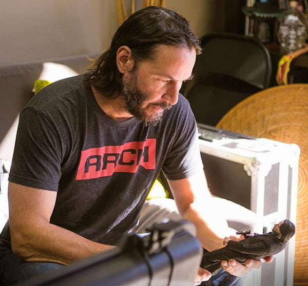 Keanu reeves checking out the john wick scale figure