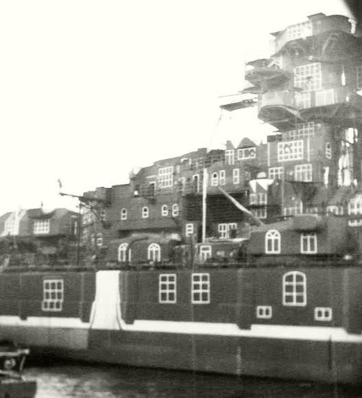 The German battleship Tirpitz camouflaged as buildings to deceive the enemy