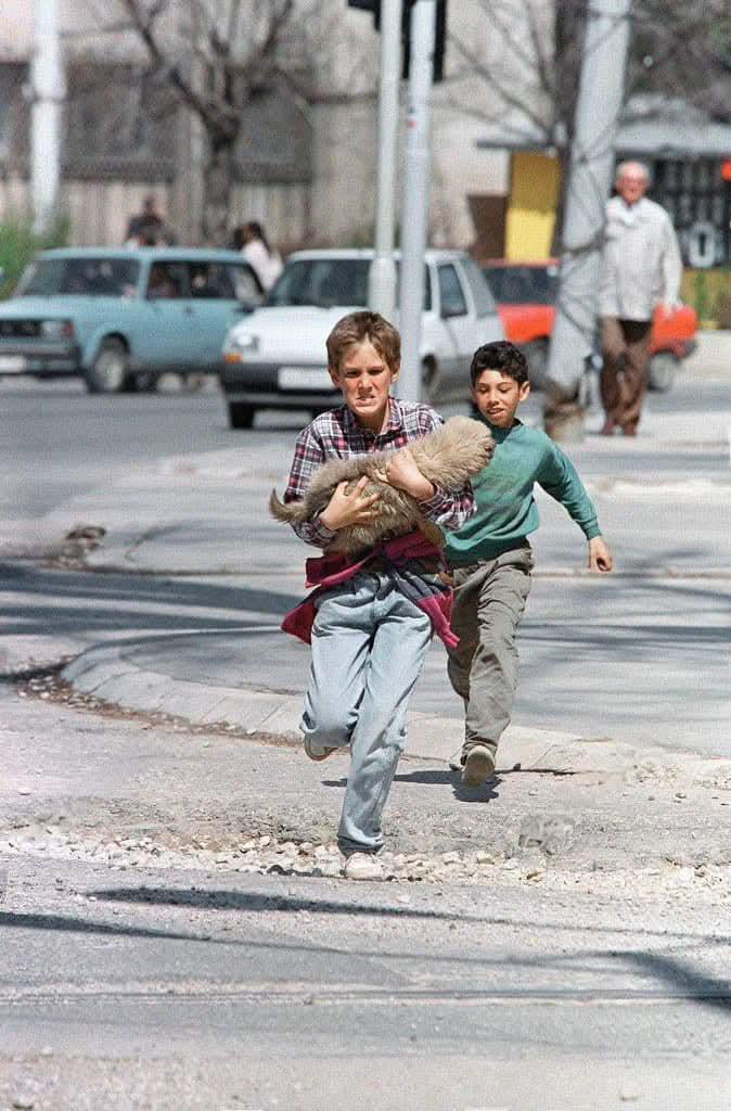 Two boys running for their lives across infamous Sniper Alley while ...