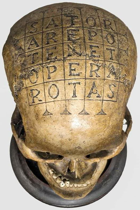 This is a 16th century German so-called 'oath skull' on which defendants  swore their oath in Vehmic courts. It is engraved with the Roman 'Sator  square', a five-line palindrome, rendered in Latin,