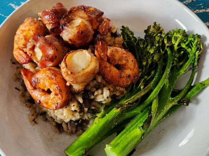Mushroom risotto with baconwrapped scallops, blackened shrimp and a