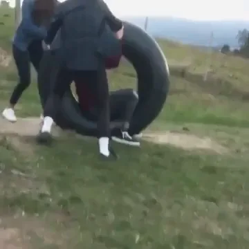 Guy in a tire rolls down hill, almost gets hit by a car and falls into a  lake - 9GAG