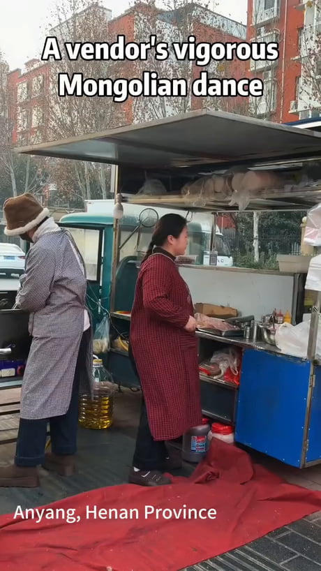 A vendor performs a Mongolian traditional dance.