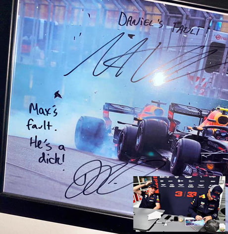 Formula 1 drivers Max Verstappen and Daniel Ricciardo sign a picture of their infamous 2018 collision