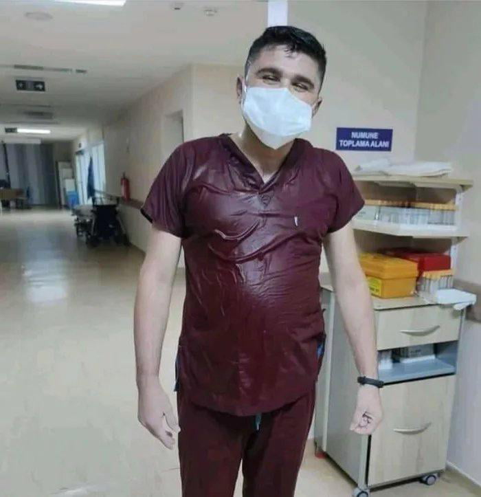The Turkish nurse takes off his protective suit after a 36 hour shift