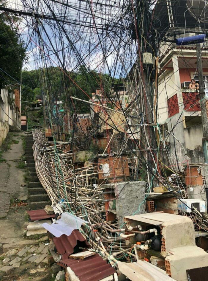 Electrical Wiring And Water Pipes In A Brazilian Favela