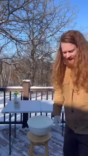 Guy freezes his hair and it stands tall.