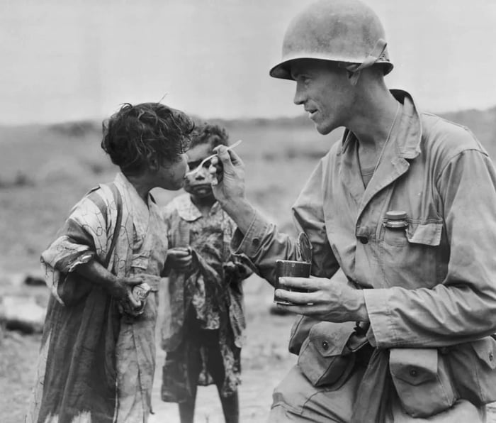 U.S. Marine feed rations to Japanese children. Okinawa, WWII, 1945 ...