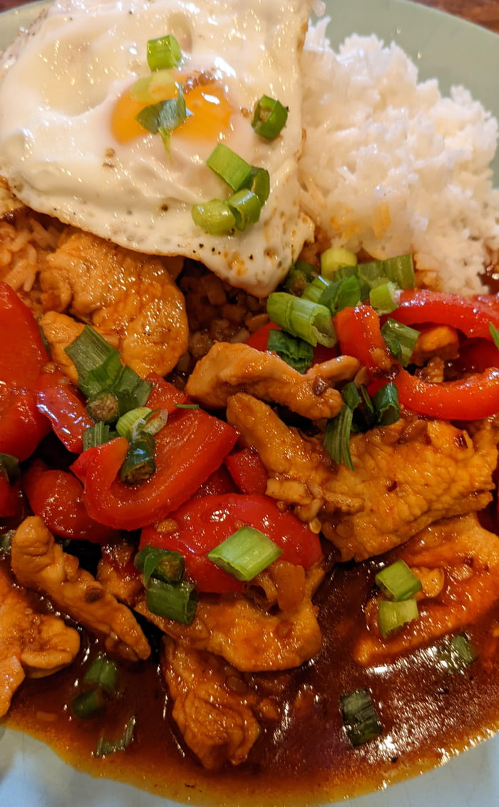 Chilli Garlic Chicken topped with crispy fried egg, spring onion and