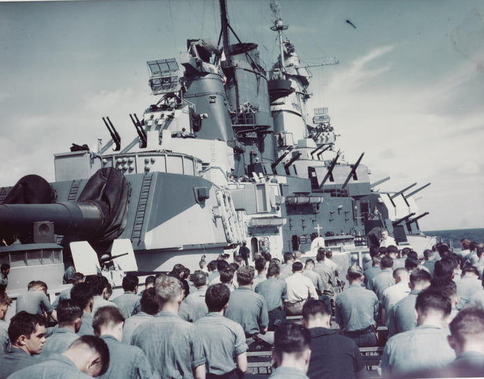 USS Iowa (BB-61) crew members attend mass on the battleship's starboard after deck, at the time of the Marianas Campaign, circa June 1944. She’s wearing Measure 32 camouflage scheme of Navy Blue (5-N) and Light Gray (5-L). USN photo.