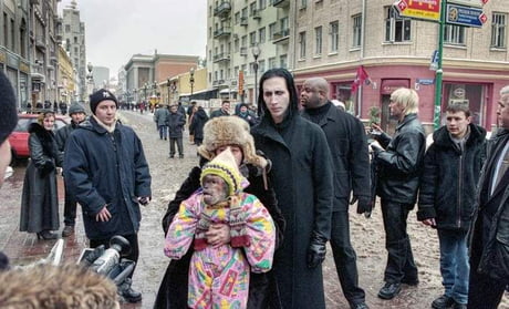 Marilyn Manson blends in perfectly with the 90s Russia, random citizen  dressed as stage goth performers from 1338 ., secret lab specimen  disguised as a baby, folks living in the moment and