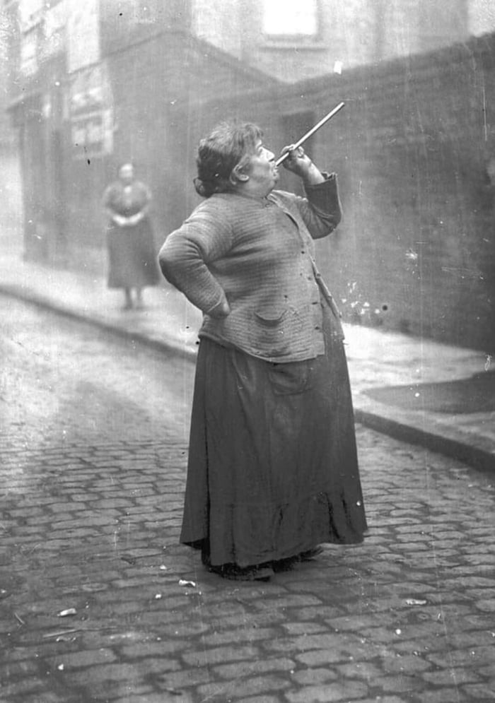 A Knocker-up was hired to ensure that people would wake up on time for their job. Mary Smith earned sixpence a week shooting dried peas at sleeping workers' windows in East London in the 1930's .