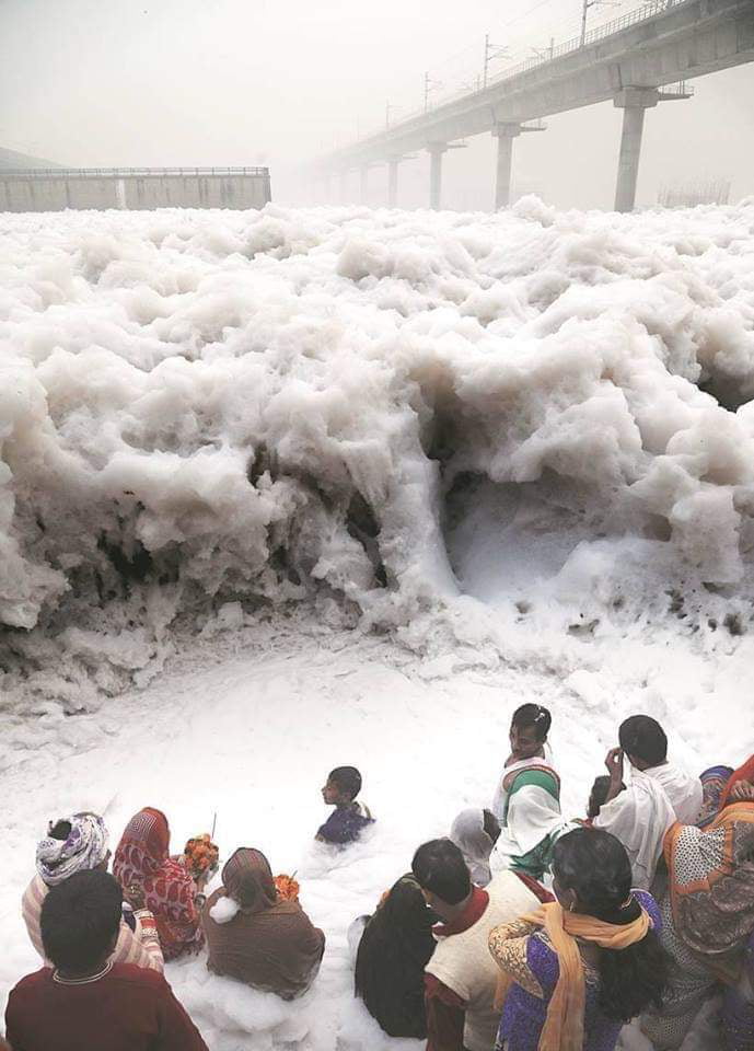 Indians offering prayers in Yamuna river filled with Industrial waste foam